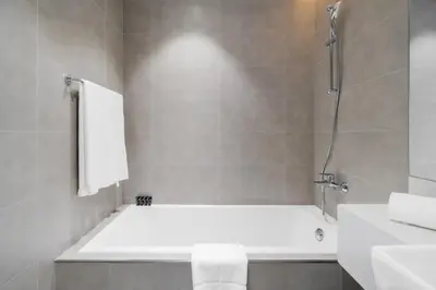a bathroom with a bath tub and a sink at Your Keys Holiday Homes in Dubai