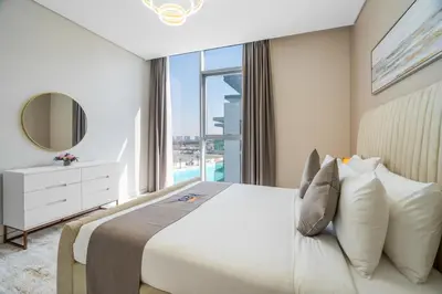 a bedroom with a large bed and a large window at Your Keys Holiday Homes in Dubai