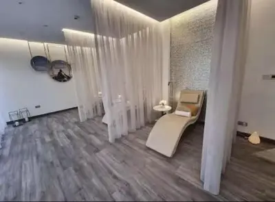 a living room with white furniture and wooden floors at Premium 2 BDR Burj Khalifa Infinity Pool View in Dubai
