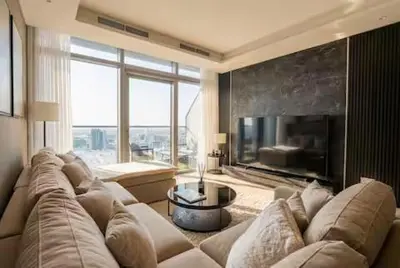a living room with a large couch and a fireplace at Premium 2 BDR Burj Khalifa Infinity Pool View in Dubai