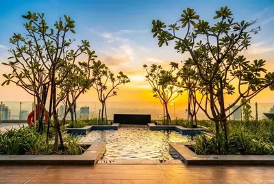 a pool in the middle of a garden with trees at Premium 2 BDR Burj Khalifa Infinity Pool View in Dubai