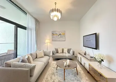 a living room with a couch and a table at Extraordinary 2BR in Prive Residence, Dubai Hills in Dubai