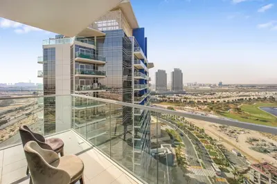 a balcony with chairs and a view of a city at Tranquil Studio with Golf View in Dubai