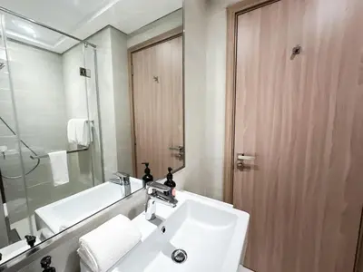 a bathroom with a sink and a mirror and a shower at EasyGo - Unbeatable Deals on Urban Rentals in Riviera 16 in Dubai
