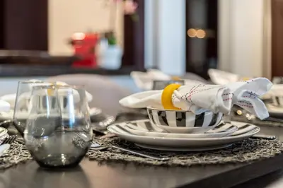 a table with a plate and glasses on a table at The Smart Concierge - Reehan 6 in Dubai