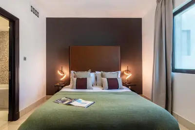 a bedroom with a bed with a book on it at The Smart Concierge - Reehan 6 in Dubai