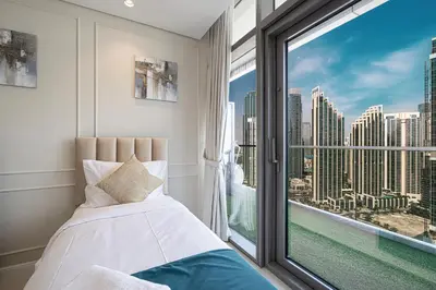 a bedroom with a bed and a large window at Boulevard 2 Bedroom Family Apartment with BURJ KHALIFA view and INFINITY POOL in 64th Floor Dubai Downtown in Dubai