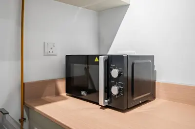 a microwave oven sitting on top of a counter at Bright Downtown Dubai Studio by Mall, Burj Khalifa & Fountains in Dubai