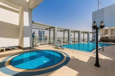 a large swimming pool on the roof of a building at Bright Downtown Dubai Studio by Mall, Burj Khalifa & Fountains in Dubai