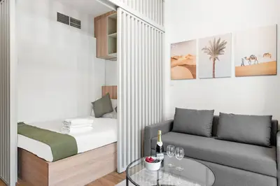 a living room with a bed and a couch at Bright Downtown Dubai Studio by Mall, Burj Khalifa & Fountains in Dubai
