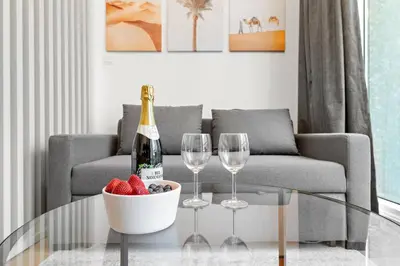 a living room with a table with wine glasses and strawberries at New Design Studio next to Burj Khalifa, Mall & Dubai Fountain in Dubai