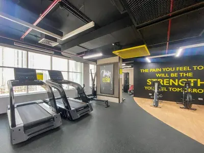 a gym with cardio equipment and a sign on the wall at New Design Studio next to Burj Khalifa, Mall & Dubai Fountain in Dubai