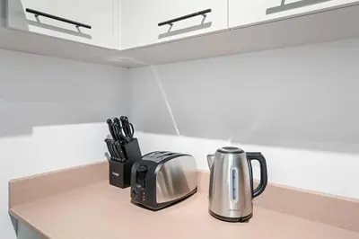 a kitchen counter with a coffee pot and a toaster at New Design Studio next to Burj Khalifa, Mall & Dubai Fountain in Dubai