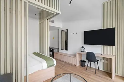 a bedroom with a bed and a tv on a wall at New Design Studio next to Burj Khalifa, Mall & Dubai Fountain in Dubai