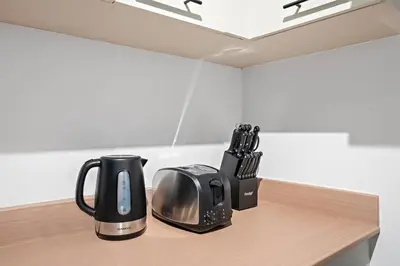 a toaster and a toaster sitting on a counter at Renovated Studio next to Dubai Mall & Burj Khalifa in Dubai