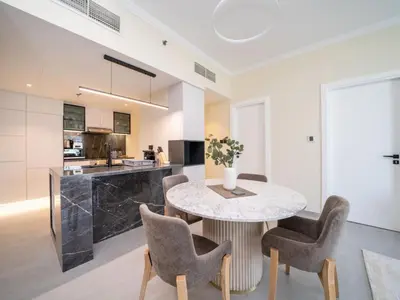 a kitchen and dining room with a table and chairs at Stylish Upgraded 1 Bedroom Marina Escape in Dubai