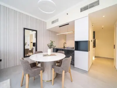 a kitchen and dining room with a table and chairs at Stylish Upgraded 1 Bedroom Marina Escape in Dubai