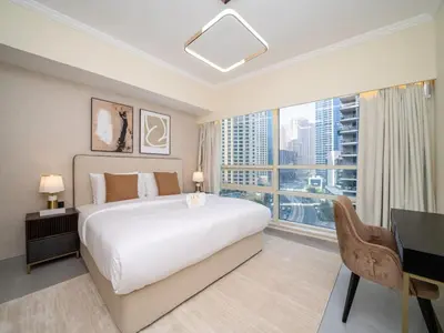 a bedroom with a large bed and a large window at Stylish Upgraded 1 Bedroom Marina Escape in Dubai