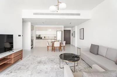 a living room with a couch and a table at Silkhaus Sea View 1BDR Exclusive Tower Beach in Dubai