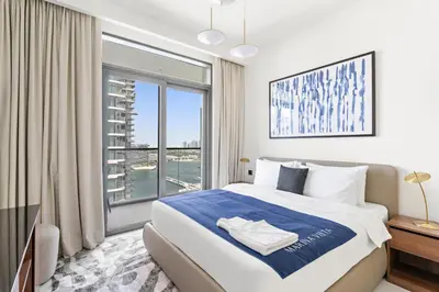 a bedroom with a bed and a large window at Silkhaus Sea View 1BDR Exclusive Tower Beach in Dubai