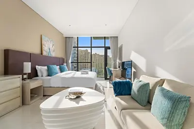 a hotel room with a bed and a living room at Stonetree - Brand New Studio - Prime Location in Dubai