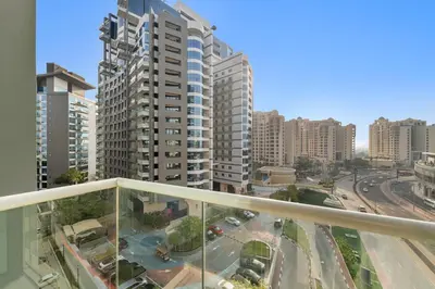 a balcony with a view of a city with tall buildings at Stonetree - Brand New Studio - Prime Location in Dubai