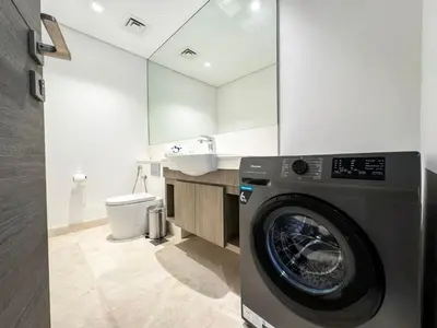 a washing machine in a bathroom with a sink at High Floor Burj Khalifa View 1BR - Business Bay in Dubai