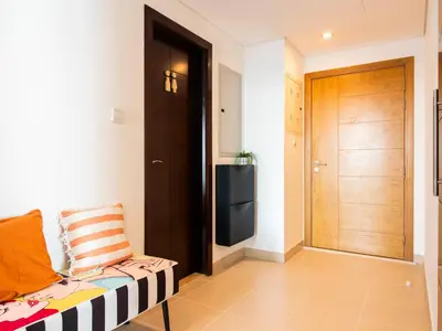 a room with a door and a chair in a room at Spacious 2BR in Downtown in High Floor in Dubai