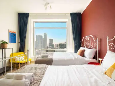 a hotel room with two beds and a large window at Spacious 2BR in Downtown in High Floor in Dubai