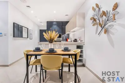 a dining room with a table and chairs at Central 1BR Apartment at Wilton Park - Host & Stay in Dubai