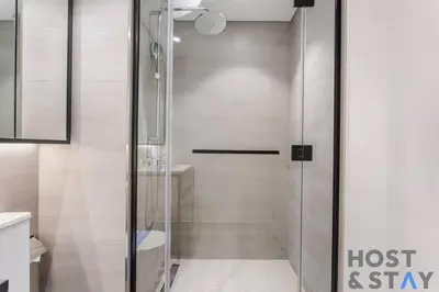 a shower with a glass door in a bathroom at Central 1BR Apartment at Wilton Park - Host & Stay in Dubai
