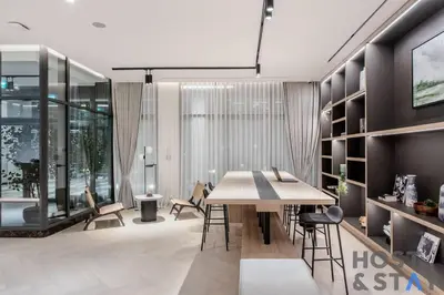 a dining room with a table and chairs at Central 1BR Apartment at Wilton Park - Host & Stay in Dubai