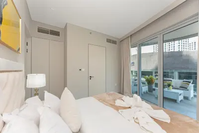 a bedroom with a large white bed with white pillows at Condor Marina Star, Dubai Marina by SIMPLY COMFORT in Dubai