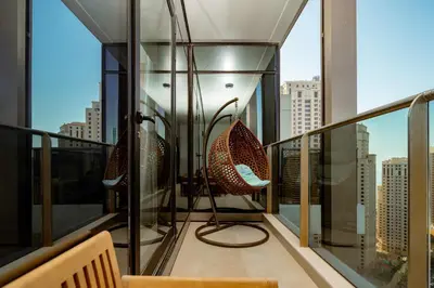 a balcony with chairs and a view of a city at Prime Retreats - Sparkle Tower Marina in Dubai