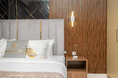 a bedroom with a bed and a wooden wall at Globalstay Creek Horizon Modern Apartments in Dubai