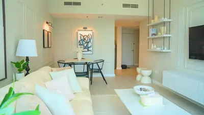 a living room with a couch and a table at Spacious 1BR, Pool, Gym, Near Dining & Shops in Dubai