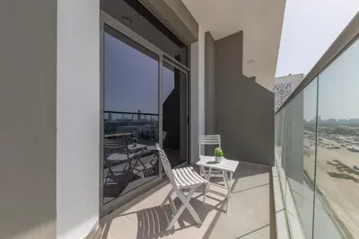 a balcony with a table and chairs on a balcony at Shining studio in Laya Heights in Dubai