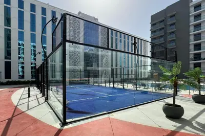 a tennis court in a building with a tennis racket at Shining studio in Laya Heights in Dubai