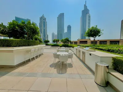 a patio with tables and chairs and a city skyline at New Elegance at Burj Crown downtown Balcony & View in Dubai