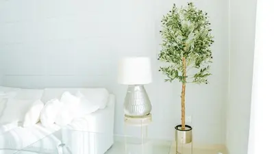 a lamp on a glass table next to a bed at New Elegance at Burj Crown downtown Balcony & View in Dubai