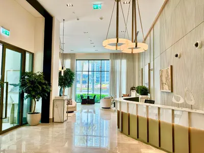 a lobby with potted plants in a building at New Elegance at Burj Crown downtown Balcony & View in Dubai