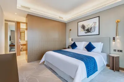 a bedroom with a large bed and a bathroom at Address Dubai Opera Residences by The S Holiday Homes in Dubai