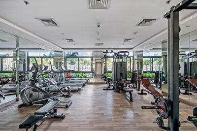 a gym with treadmills and cardio machines at Peacefull Studio - Arjan in Dubai