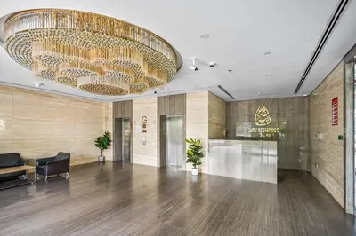 a lobby with a large chandelier hanging from the ceiling at Peacefull Studio - Arjan in Dubai