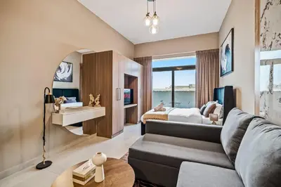 a living room with a couch and a bed at Peacefull Studio - Arjan in Dubai