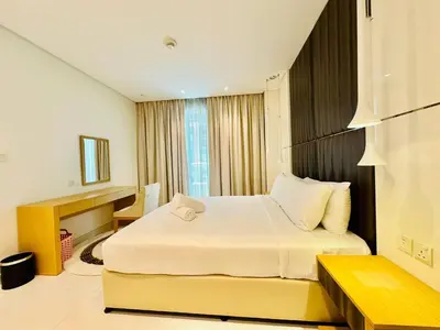 a hotel room with a bed and a window at 5 Star Hotel Residence Apartment- Walking to Downtown Dubai Mall in Dubai