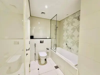 a bathroom with a toilet and a tub and a sink at 5 Star Hotel Residence Apartment- Walking to Downtown Dubai Mall in Dubai