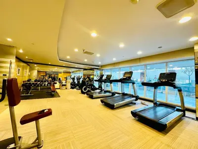 a gym with several treadmills in a building at 5 Star Hotel Residence Apartment- Walking to Downtown Dubai Mall in Dubai