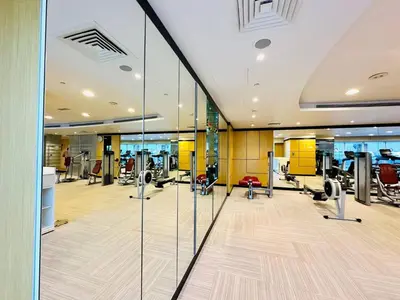 a gym with treadmills and elliptical machines at 5 Star Hotel Residence Apartment- Walking to Downtown Dubai Mall in Dubai