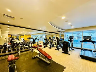 a gym with treadmills and exercise equipment in a building at 5 Star Hotel Residence Apartment- Walking to Downtown Dubai Mall in Dubai